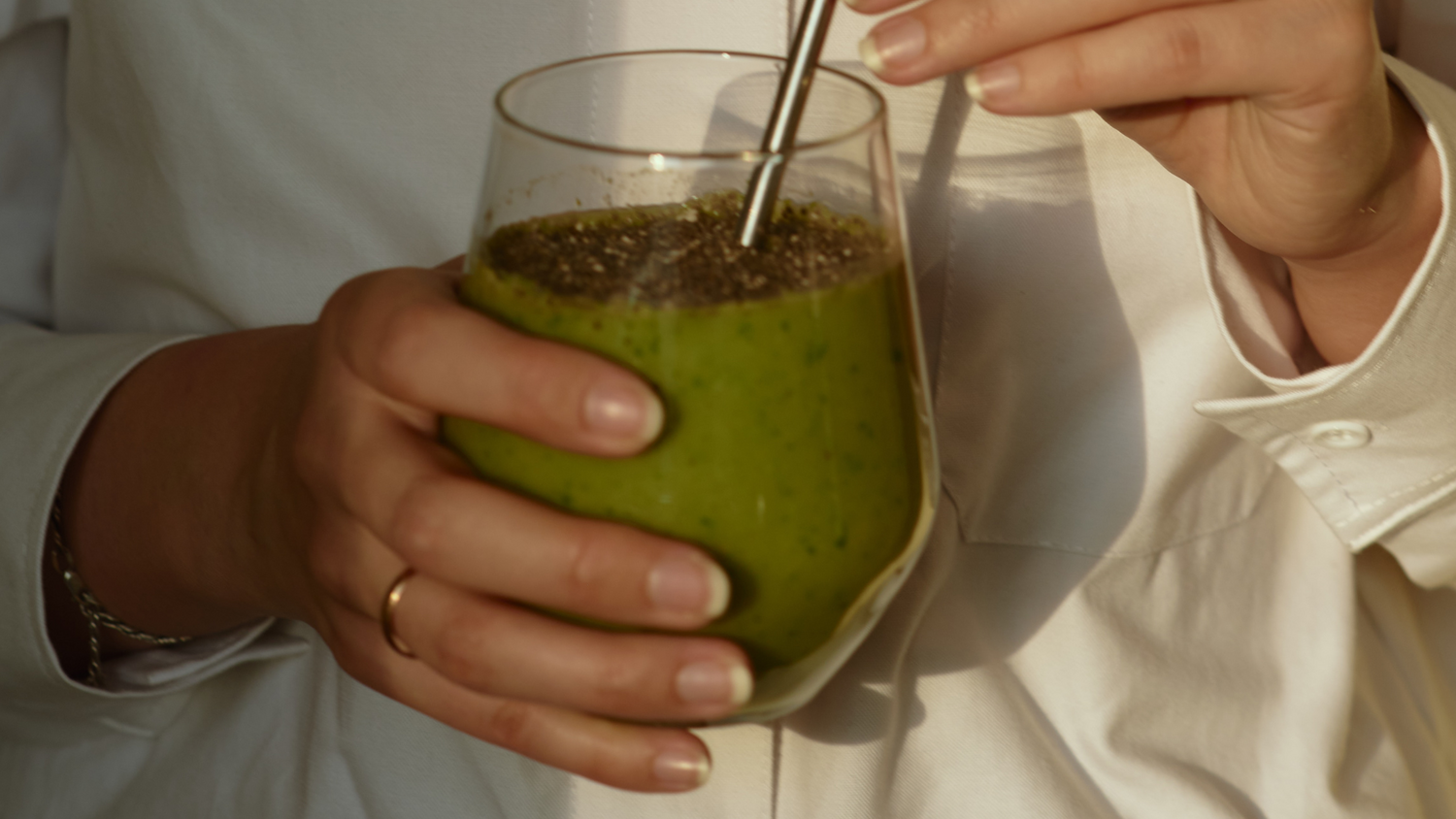 woman drinking green juice on a plant based diet 