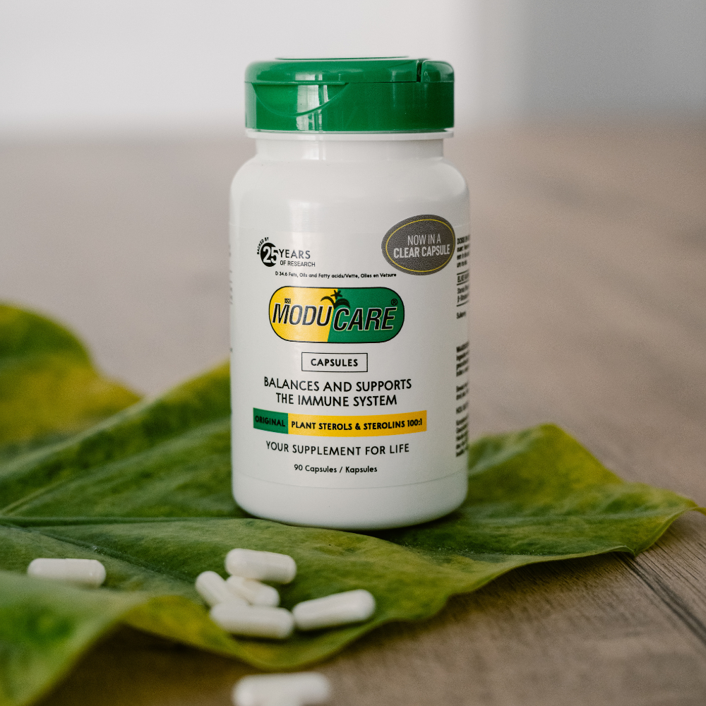 Moducare supplement bottle with green cap on a leaf