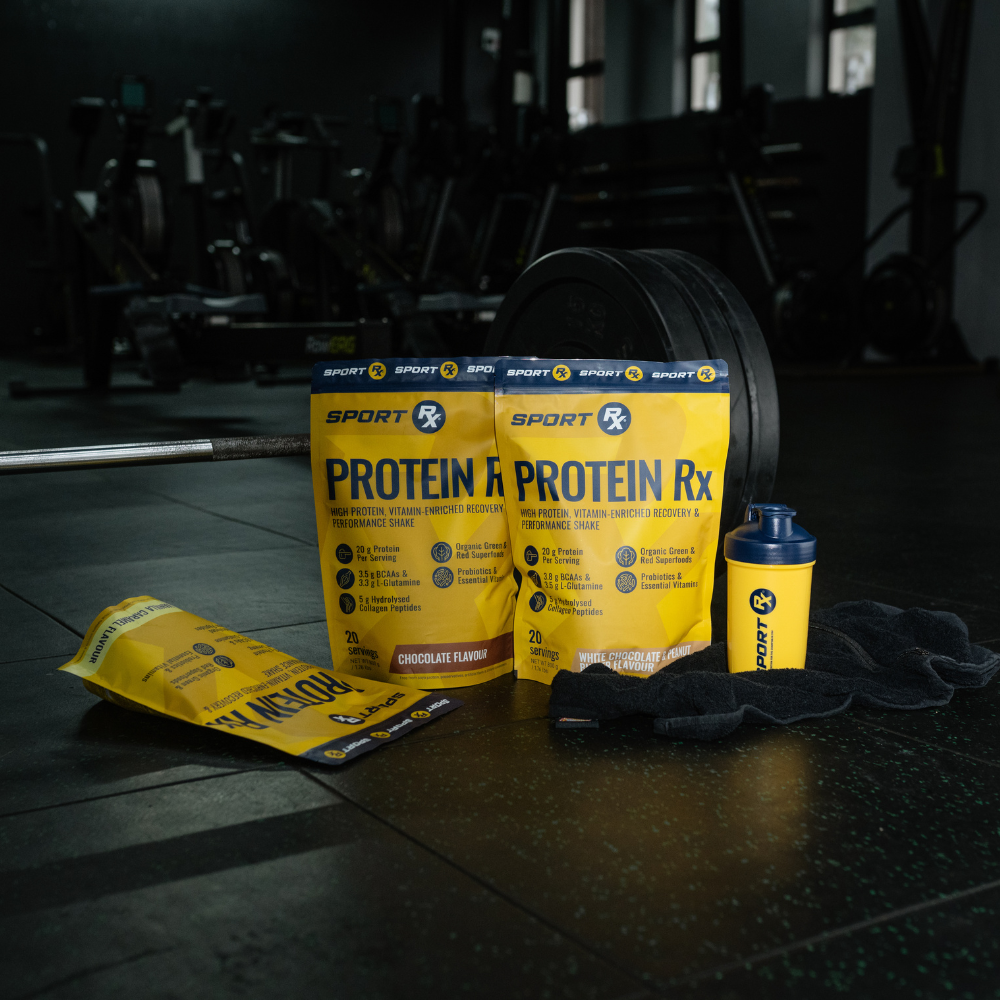Sport Rx Protein Rx packages with a shaker bottle on a gym floor.