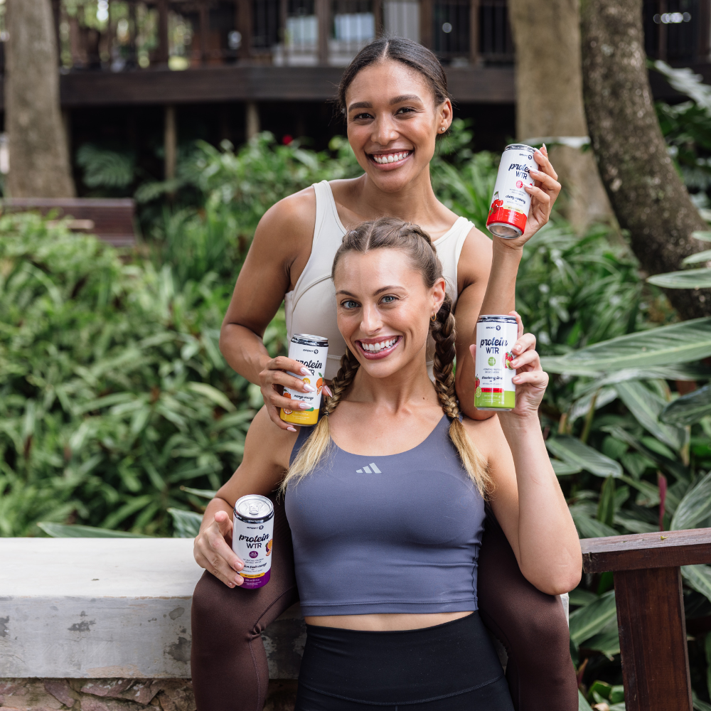 Two women holding SPORT Rx Protein WTR