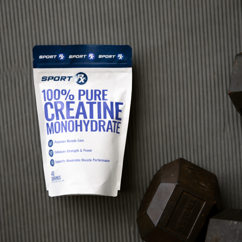 Package of Sport X 100% Pure Creatine Monohydrate on a textured surface with a dumbbell in the foreground.