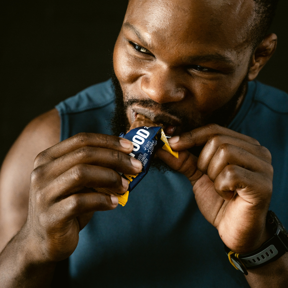 Man eating a protein bar by Sport Rx