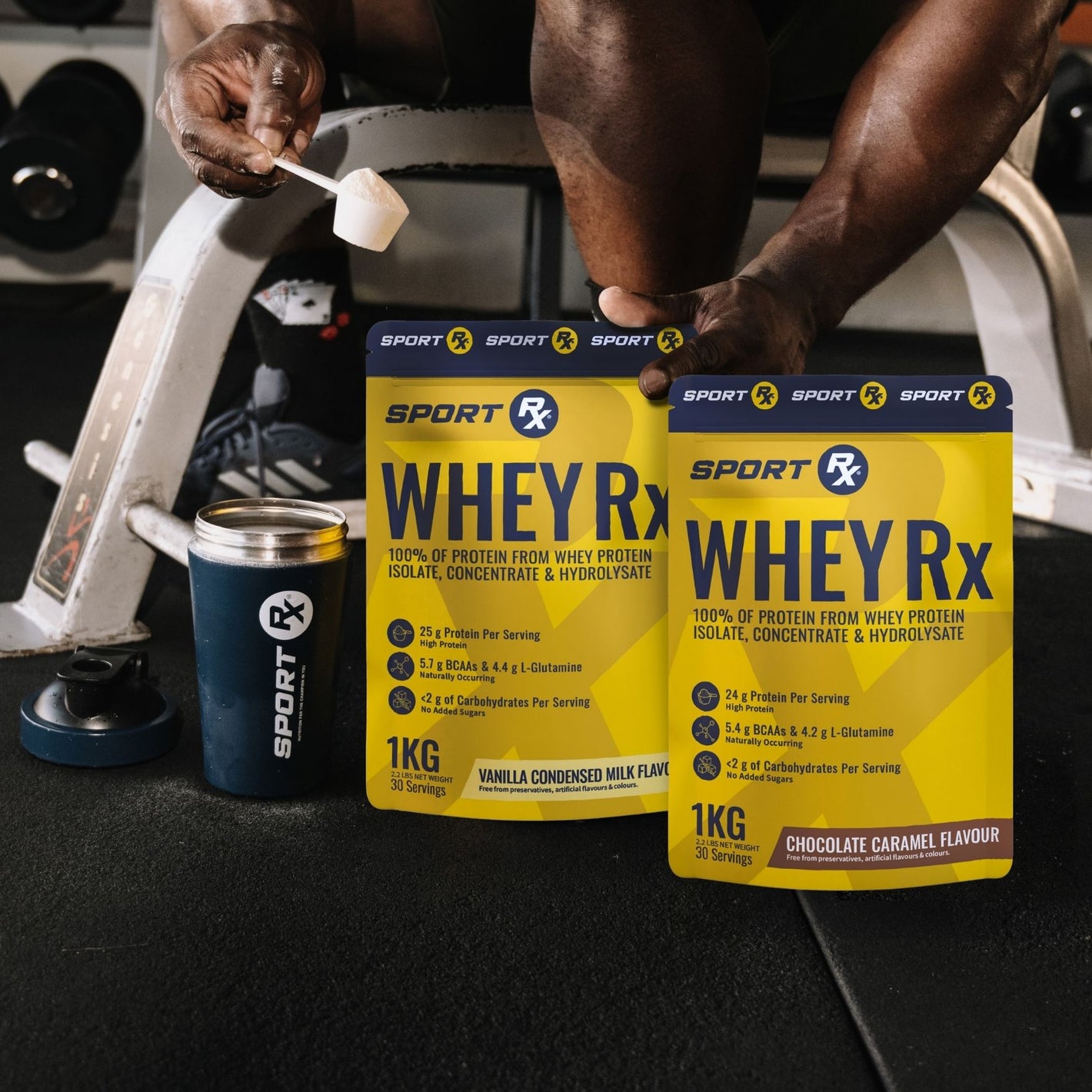 SPORT_Rx_Athlete_Scooping_WHEY_Rx_Product_With_SPORT_Rx_Shaker_In_A_Gym_Setting