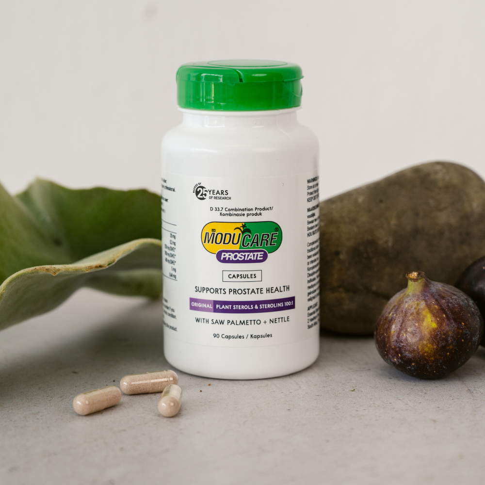 Moducare Prostate supplement bottle with capsules and figs on a neutral background
