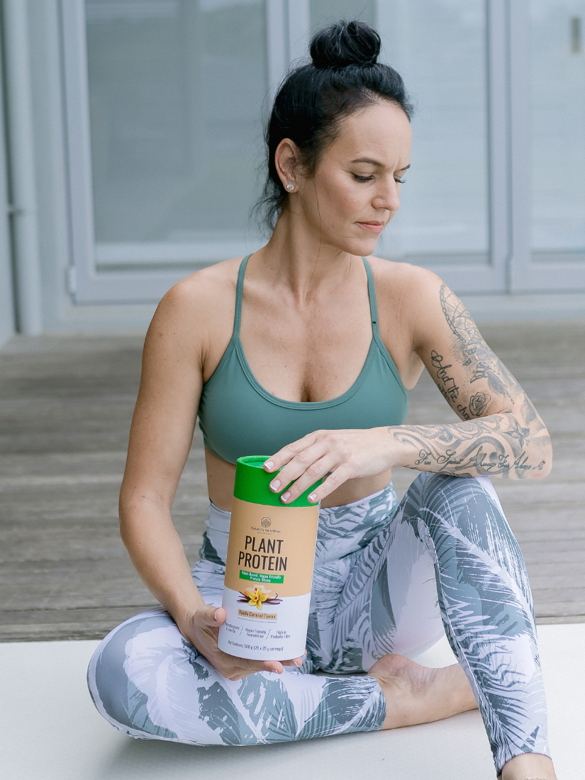 Nature's Nutrition Yoga Women holding Caramel Plant Protein