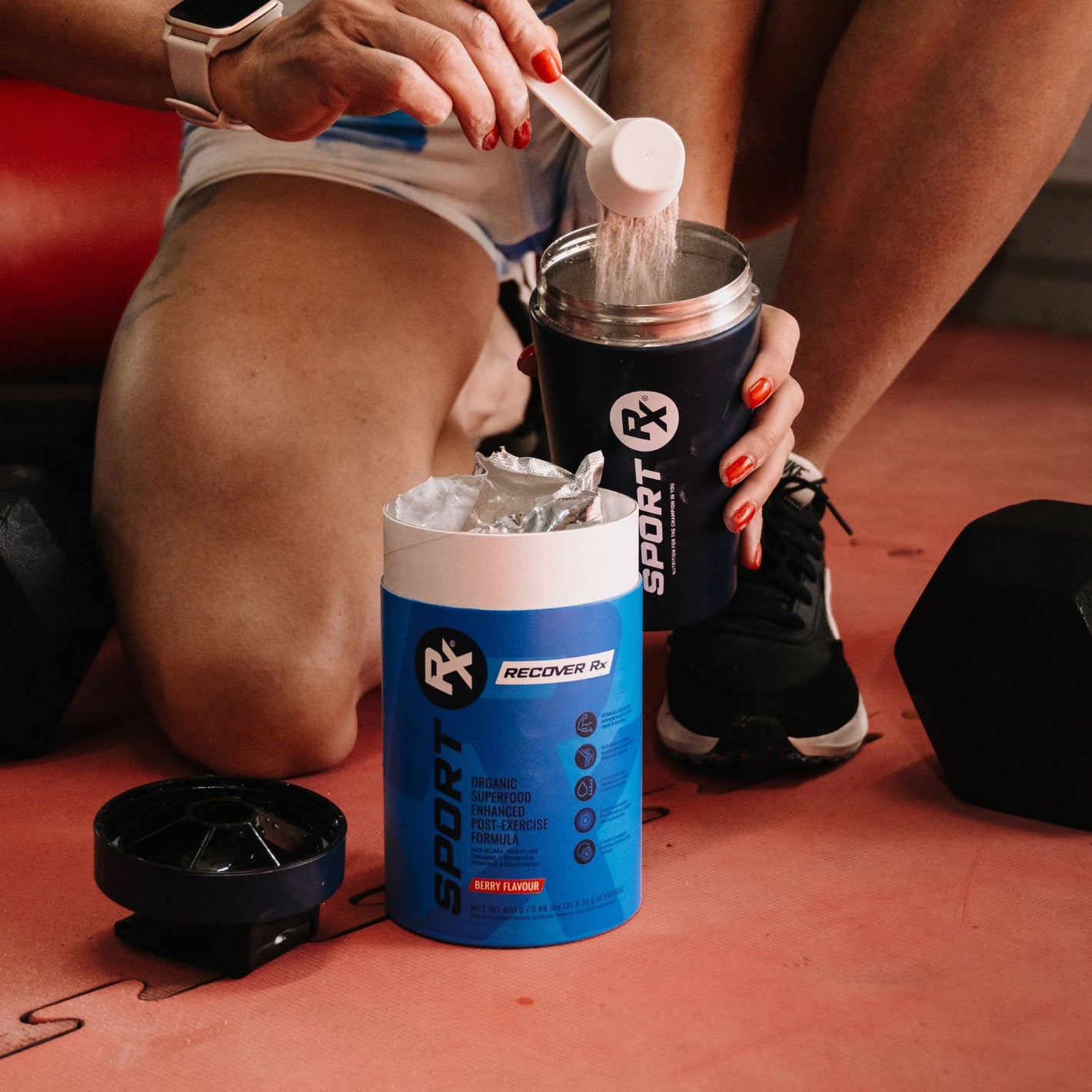 SPORT_Rx_Athlete_Scooping_RECOVERY_Rx_Product_Into_A_SPORT_Rx_Shaker_In_A_Gym_Setting
