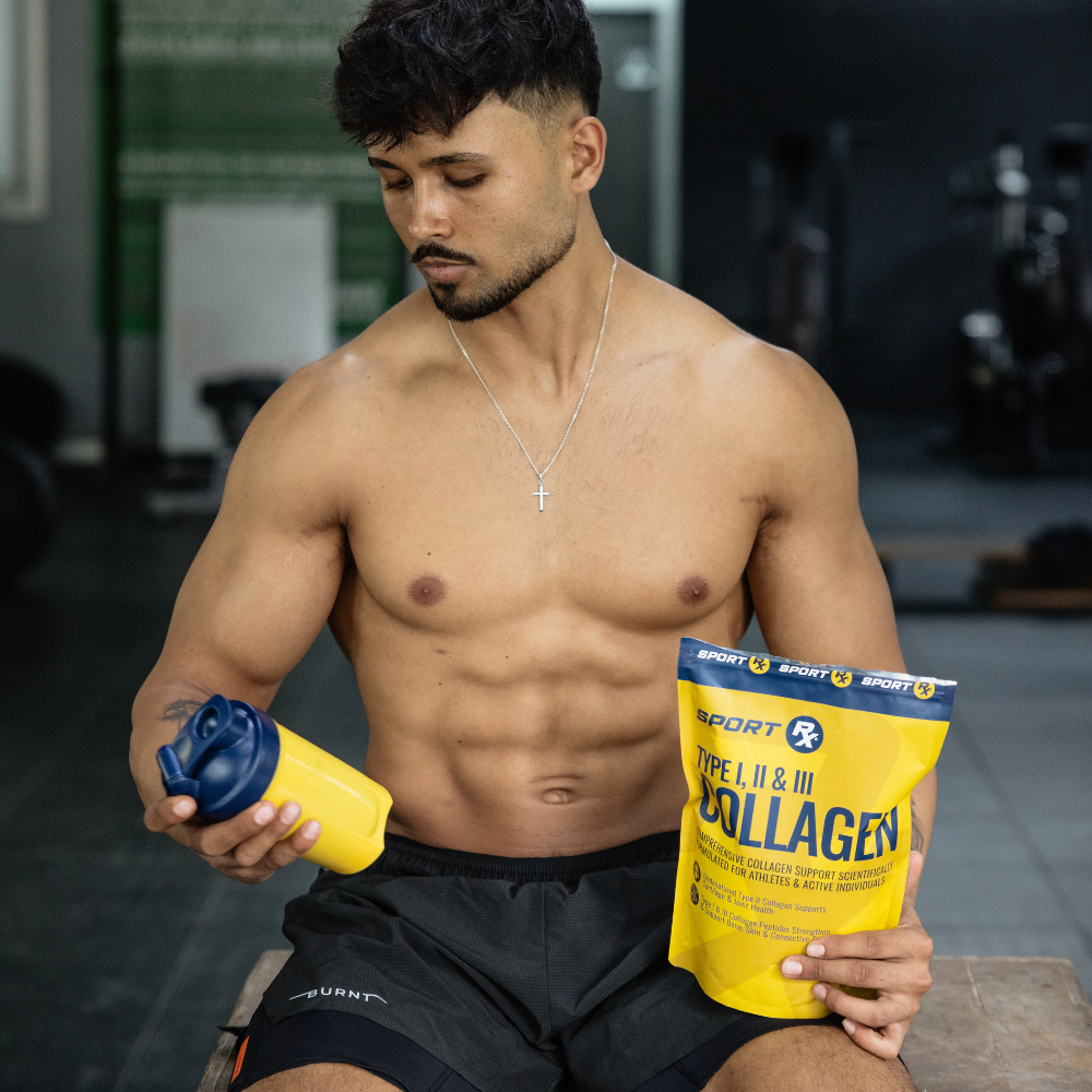 Muscular man holding a supplement container and a package of Sport Rx Collagen in a gym setting.