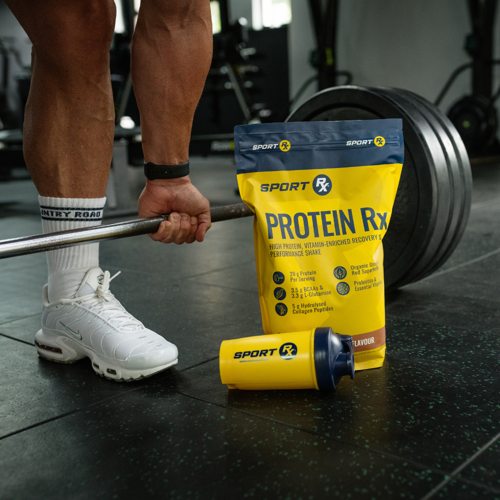 Person lifting weights with a Protein Rx supplement package on the floor.