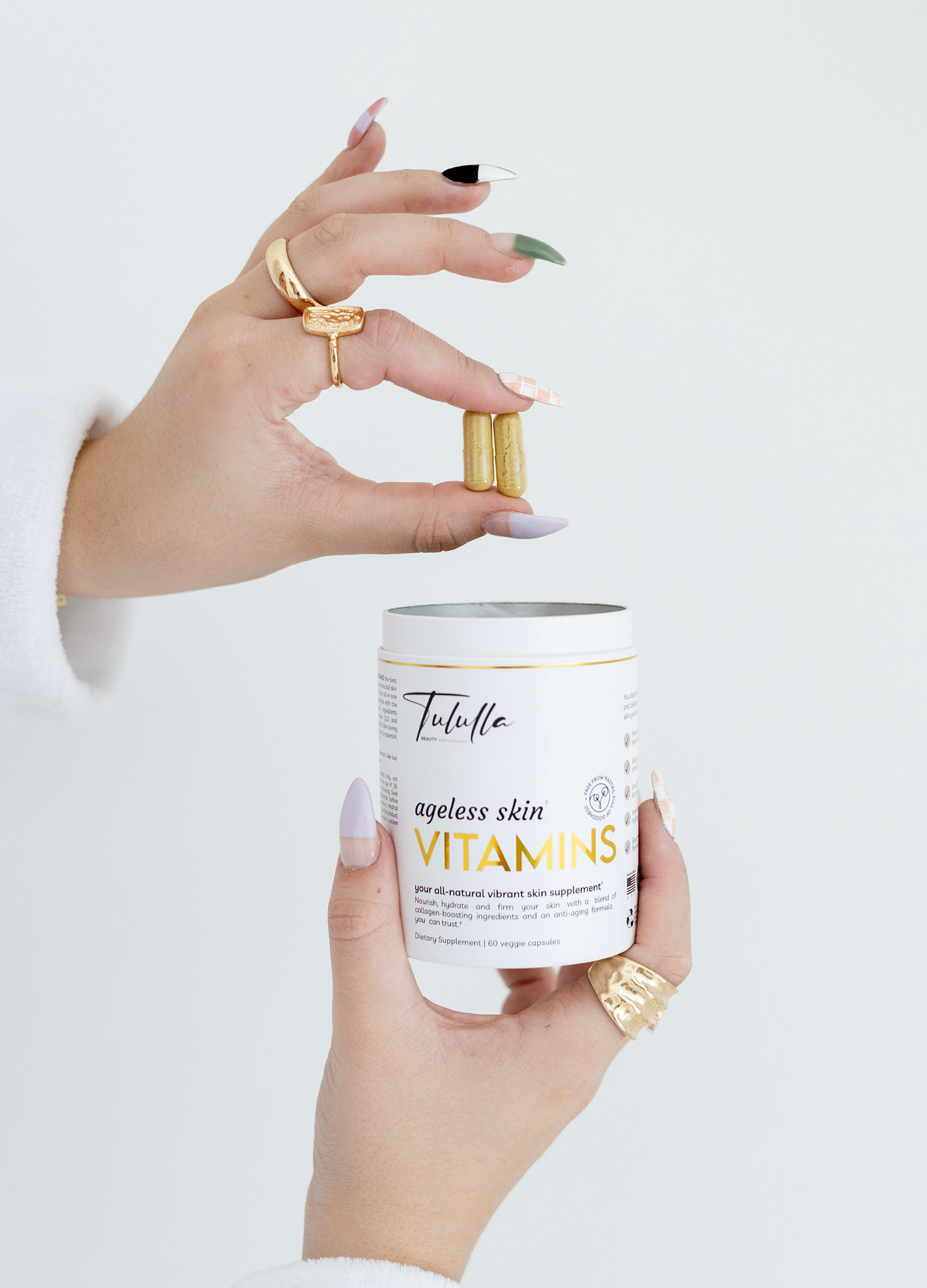 Tululla_ageless_skin_VITAMINS_With_Capsules_In_Hand_Displayed_In_A_Neutral_Setting